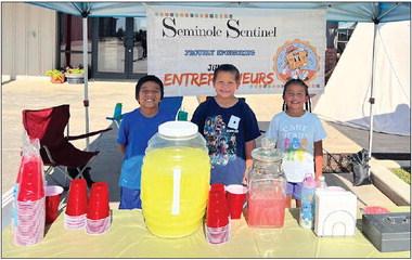 Three young entrepreneurs Frank Carrillo (left), Edgar Vazquez (center), and Jasmine Carrillo (right) learn the value of hard work and responsibility at their lemonade stand located at the Heritage Farmer's Market. (Sentinel photo/Jessenia Balderas)