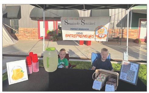 Two young entrepreneurs, Wyatt (left) and Eugene Dyck (right) beam with excitement as they showcase their handmade sweets and treats at the Heritage Farmer’s Market, ready to embark on their small business journey. (Sentinel photo/ Jessenia Balderas)