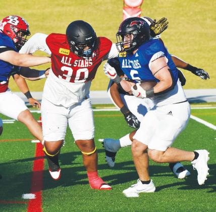 Red Team defensive lineman Jaylen Cottrell of Seminole gets ready to tackle Blue Team running back Kouper Boyd of Shallowater during the first half of the 2024 ASCO All-Star Classic on Saturday at Lowrey Field in Lubbock. (Melissa McCaghren, Brownfield Editor)